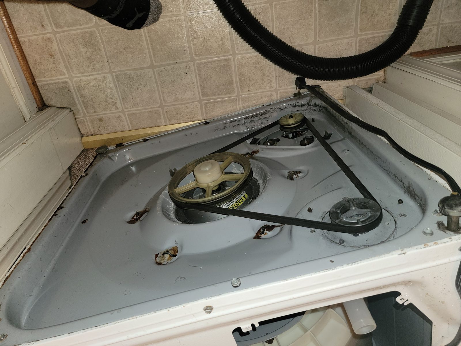 Older belt-driven washing machine with the belt drive assembly exposed